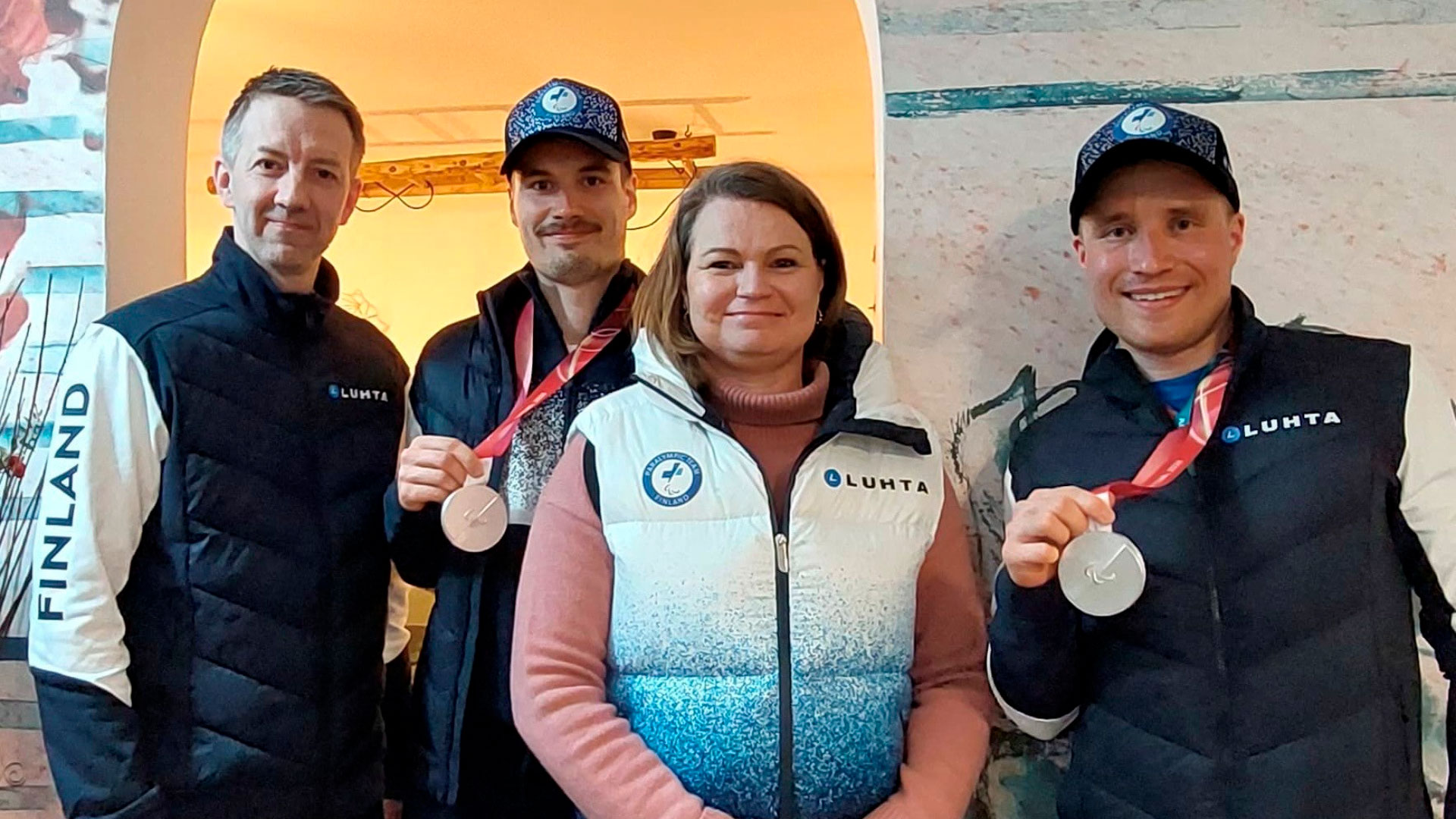 JYSKin viestintäpäällikkö Taija Paavola poseeraamassa Paralympiakomitean kumppanuuspäällikkö Timo Mäkysen sekä paralympiamaastohiihtäjä Inkki Inolan ja hänen oppaansa Reetu Inkilän kanssa. 